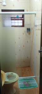 a bathroom with a shower with a toilet and a sink at Casa Próximo Centro Itanhaém in Itanhaém +20 photos