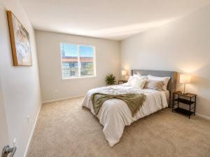 a bedroom with a large bed and a window at mamihomes redondo beach in Redondo Beach