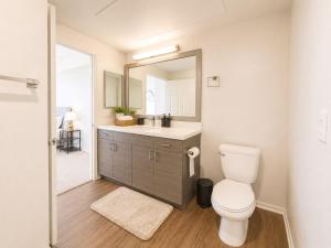 a bathroom with a toilet and a sink and a mirror at mamihomes redondo beach in Redondo Beach +10 photos