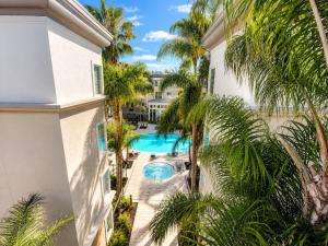an aerial view of a building with a pool and palm trees at mamihomes redondo beach in Redondo Beach