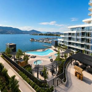 a resort with a pool and a body of water at Paradise on the Lake in Kelowna
