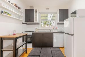 a kitchen with white appliances and a wooden table at Cute and cozy cottage in Northfield