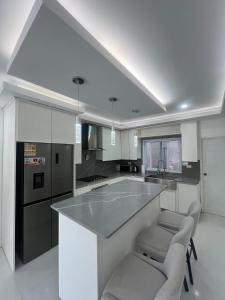 a kitchen with a large island with two chairs at Deluxe two 2 bedroom in Priory