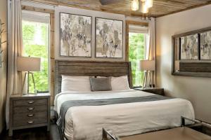 a bedroom with a bed with two lamps and two windows at Million Dollar Mountain Views in Gatlinburg