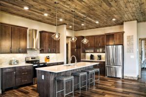 a kitchen with wooden cabinets and a stainless steel refrigerator at Million Dollar Mountain Views in Gatlinburg