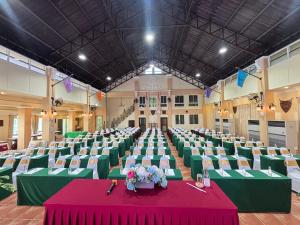 a large hall with green tables and chairs and a table with flowers at Wellness World Chiva Khao Yai in Ban Wang Sai +53 photos