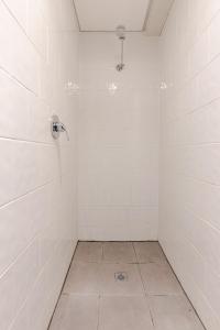 a bathroom with a shower with white tiles at Cute and cozy cottage in Northfield +16 photos
