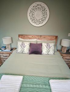 a bedroom with a large bed with two lamps at Sunset Te Kamo in Whangarei