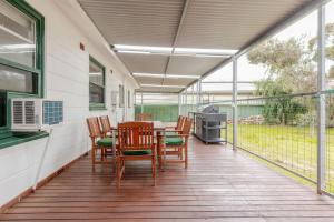 a porch with a table and chairs on it at Cute and cozy cottage in Northfield