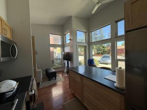 a kitchen with a counter top and some windows at The Hanson Hideaway in Whitehorse +4 photos