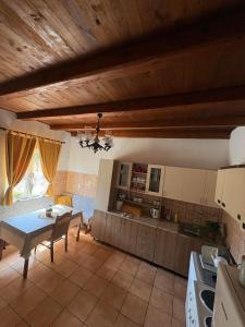 a kitchen with a table and a dining room at Kuća za odmor in Trebinje