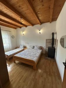 a bedroom with two beds and a fireplace in it at Kuća za odmor in Trebinje
