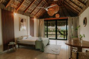 a bedroom with a bed and a large window at Montero Residences in Brisas de Zicatela