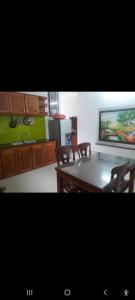 a dining room with a table and chairs and a tv at Lockhang homestay in Thanh Ðông (1)