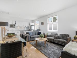 a living room with a couch and a table at Hobart Cityscape in Hobart