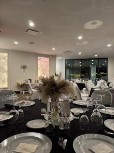 a dining room with a table with plates and glasses at The Royal Anne Hotel in Kelowna