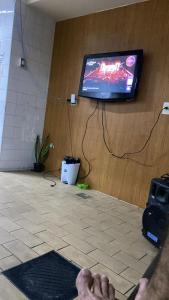 a person laying on the floor in front of a tv at Rede Quartos in São Paulo +3 photos