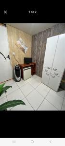 a room with a desk and two doors in a room at Rede Quartos in São Paulo