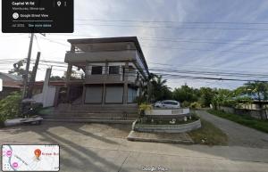 a house with a car parked in front of it at Casa Kristar in Mamburao