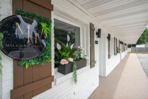 a sign on the side of a building with plants at Cashmere Private Studio Cozy Chic Escape in Kokomo +3 photos
