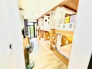 a room with wooden flooring and stairs in a house at Lamer Hostel in Cat Ba