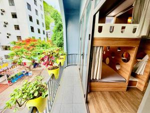 a balcony of a building with potted plants at Lamer Hostel in Cat Ba
