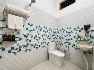 a bathroom with a toilet and a sink at Viraj Guest House in Ayodhya +28 photos