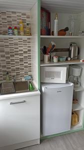 a refrigerator freezer sitting inside of a kitchen at Halte à Veyrac in Lavoûte-sur-Loire