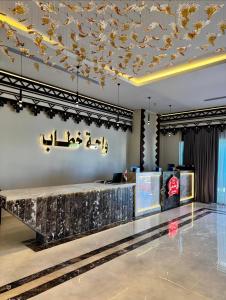 a lobby with a reception desk and a chandelier at Modern Hotel-Style Apartment in El Alamein +52 photos