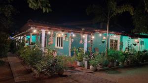 a house with plants in front of it at night at Family Nest in Dambulla +30 photos