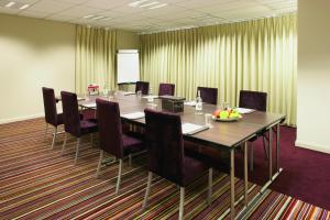 a conference room with a long table and chairs at ABode Canterbury in Canterbury