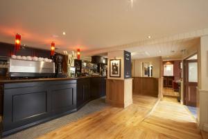 a bar in a pub with wooden floors at ABode Canterbury in Canterbury