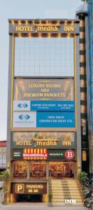 a building with a lot of signs on it at Hotel MEDHA Inn in Patna