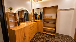 a dressing room with wooden cabinets and a mirror at Villa Lourdes in Alaminos +9 photos