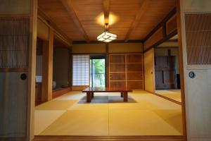 a room with a table in the middle of it at Yamanoto in Toyooka