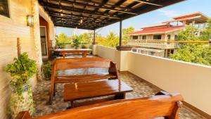 a row of benches sitting on a balcony at Villa Lourdes in Alaminos