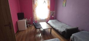 a room with a bed and a table and a window at Apartament M J w Centrum-Dwa Pokoje in Ząbkowice Śląskie +5 photos