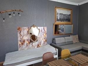 a bedroom with a bed and a mirror on the wall at Apartament M J w Centrum-Dwa Pokoje in Ząbkowice Śląskie