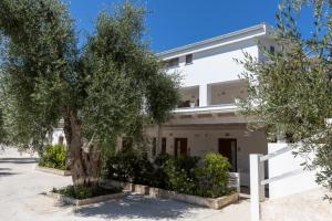 a white building with trees in front of it at La Duchessa e Il Contadino in Vieste