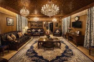 a living room filled with furniture and a chandelier at Floating Luxury Group Of Houseboats in Srinagar