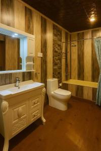 a bathroom with a sink and a toilet and a tub at Floating Luxury Group Of Houseboats in Srinagar +16 photos