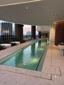 a large swimming pool in the middle of a building at OMI Collection Broadbeach in Gold Coast
