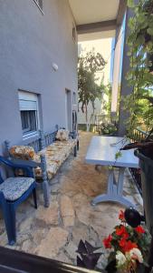 a patio with a couch and a table in a building at Olga 112 in Bar +8 photos