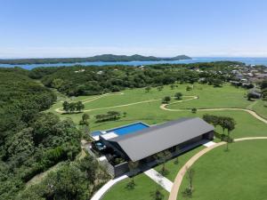 an aerial view of a building with a swimming pool in a park at Nemu Resort Hotel Nemu in Shima