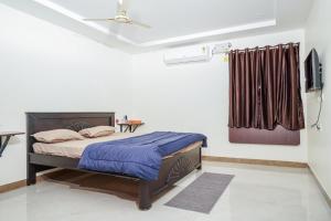a bedroom with a bed and a television in it at My3 rooms in Vijayawāda