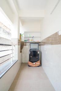 a room with a tv sitting in the corner of a room at My3 rooms in Vijayawāda