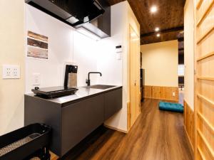 a kitchen with a sink and a counter top at 奈良旅館 VILLA East West in Nara +26 photos