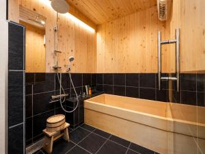 a bathroom with a tub and a shower at 奈良旅館 VILLA East West in Nara