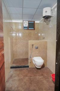 a bathroom with a toilet and a shower at My3 rooms in Vijayawāda