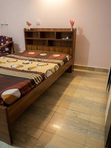a bed in a room with a wooden floor at Cozy Comfy 2 in Hithadhoo